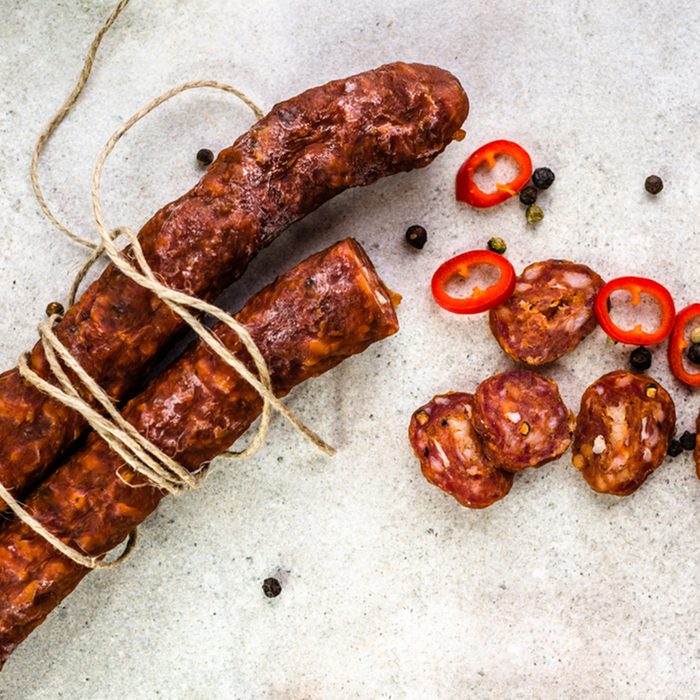 Food from spain, chorizo sausage slices or salami pepperoni, traditional spanish tapas, overhead.