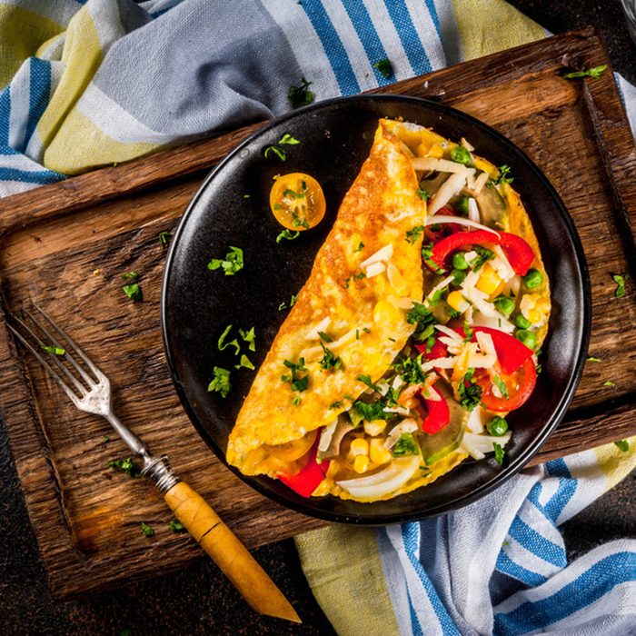 Healthy breakfast food, Stuffed egg omelette with vegetable, dark concrete background 