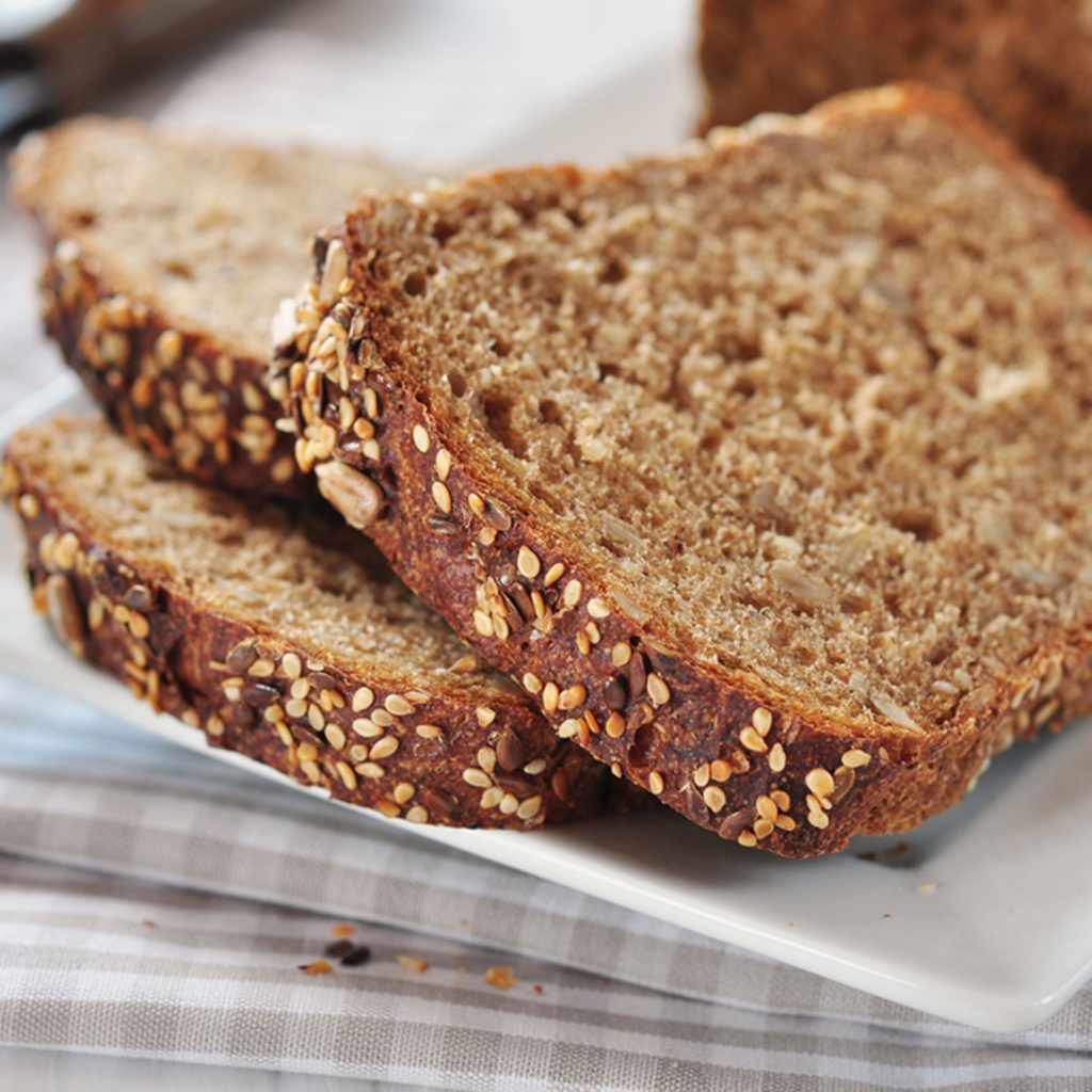 Sliced bread with sunflower seeds and sesame on a plate