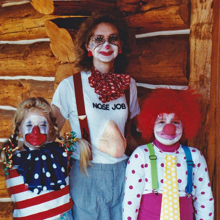 woman and two children dressed in costumes for Halloween