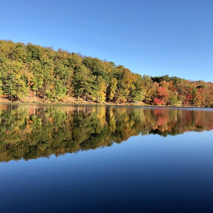 Serene lake discovered in the Pocono Mountains on a beautiful Fall morning.