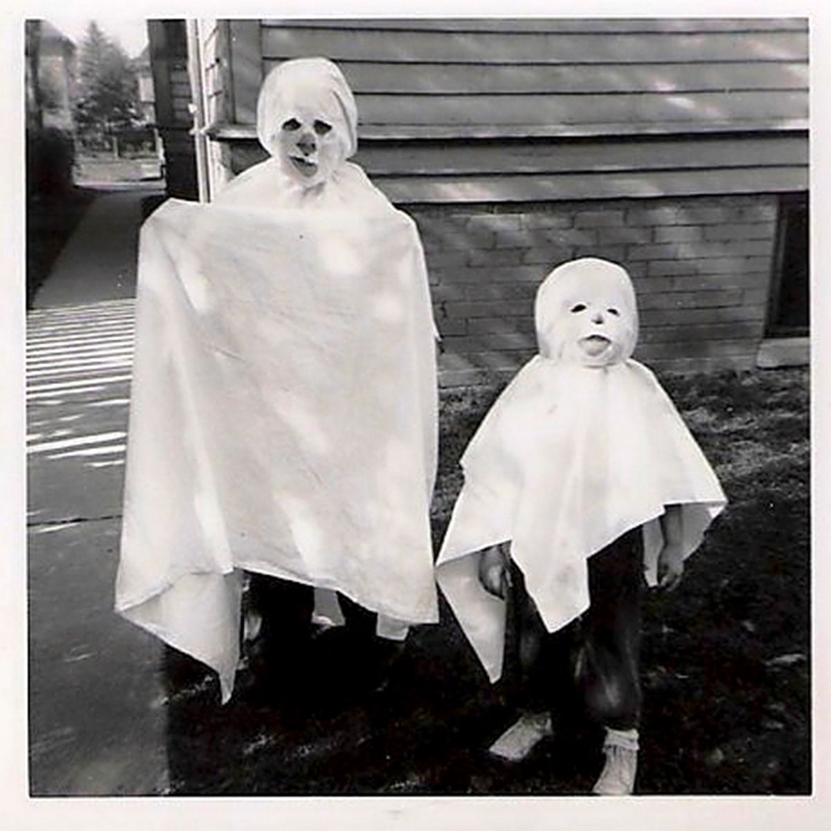 children in ghost costumes on Halloween