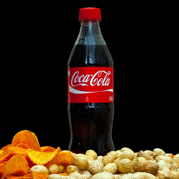 plastic bottle of soft drink coca-cola by coca-cola company on black background