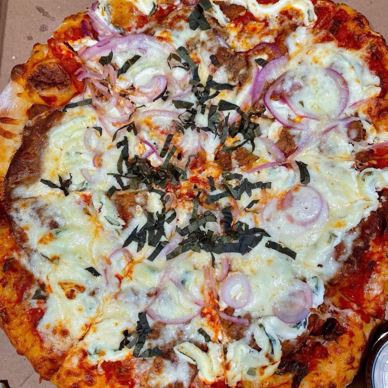 close up of a pizza with cheese and onions from the Best Pizza in Boston Massachusetts
