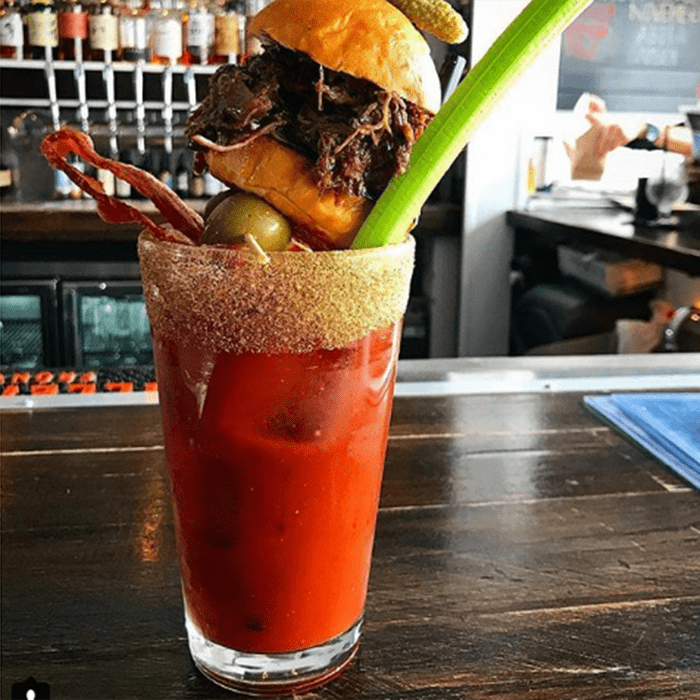 Bloody Mary topped with a celery stick and slider