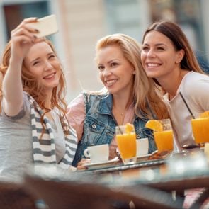Friends having a great time in cafe.Friends smiling and sitting in a coffee shop, drinking coffee and enjoying together.; Shutterstock ID 1131394877; Job (TFH, TOH, RD, BNB, CWM, CM): TOH Girls Getaway