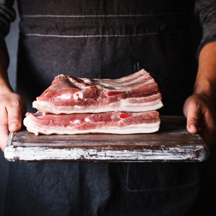 Pork Belly butcher person curring bacon porchetta