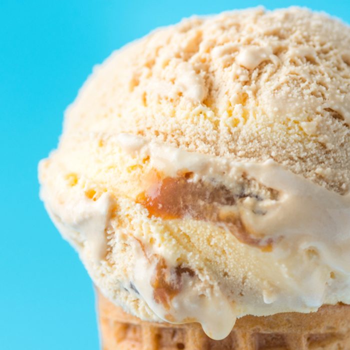 Scoop of Delicious Melting Salted Caramel Toffee Vanilla Ice Cream in Waffle Cone on Blue Background. Summer Sweets Sugar Addiction Indulgence Concept. Recipe Template. Copy Space; Shutterstock ID 1084833002; Job (TFH, TOH, RD, BNB, CWM, CM): Taste of Home