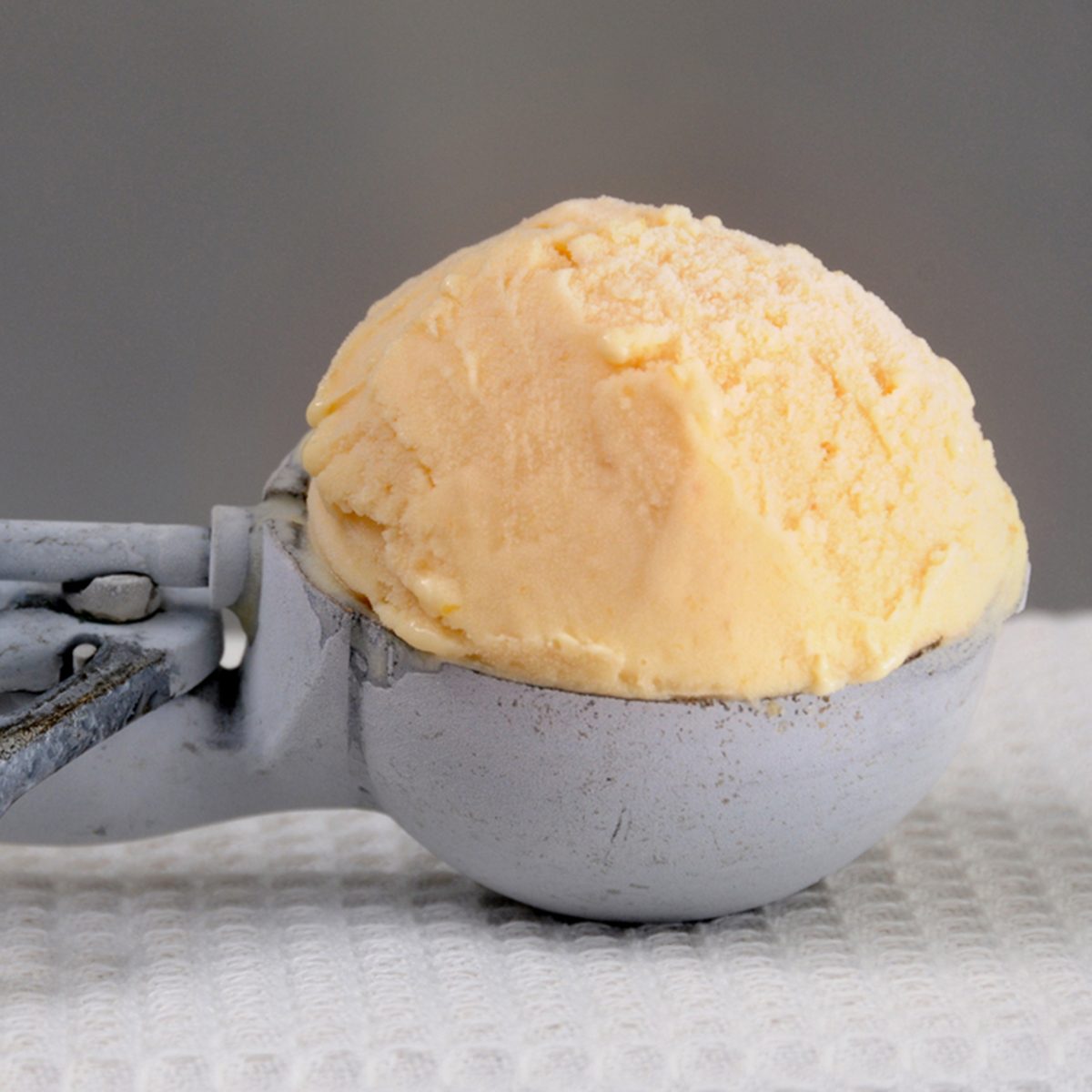 Homemade Peach Ice Cream in Vintage Scoop; Shutterstock ID 181115030; Job (TFH, TOH, RD, BNB, CWM, CM): Taste of Home