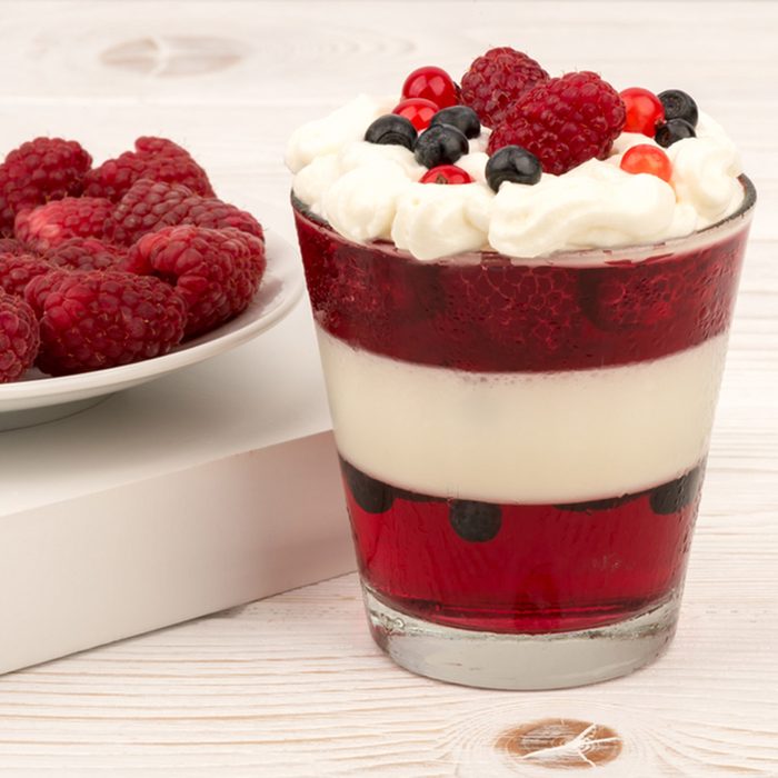 Sweet dessert in glass with cream, jell, raspberries and blueberries on wooden background.; Shutterstock ID 303953327; Job (TFH, TOH, RD, BNB, CWM, CM): Taste of Home