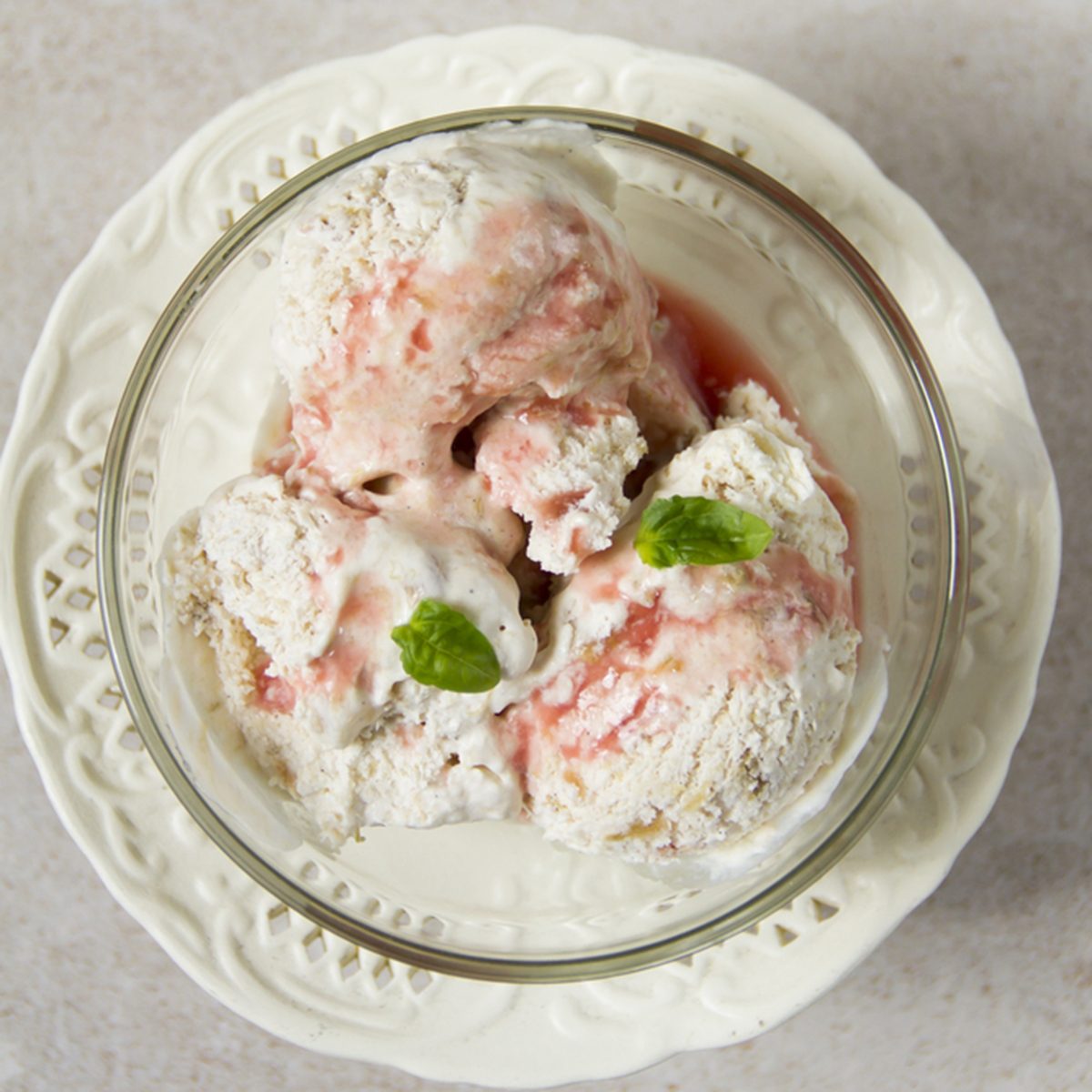 Rhubarb ice cream, beige background, glass bowl, white plateau.; Shutterstock ID 418119010; Job (TFH, TOH, RD, BNB, CWM, CM): Taste of Home