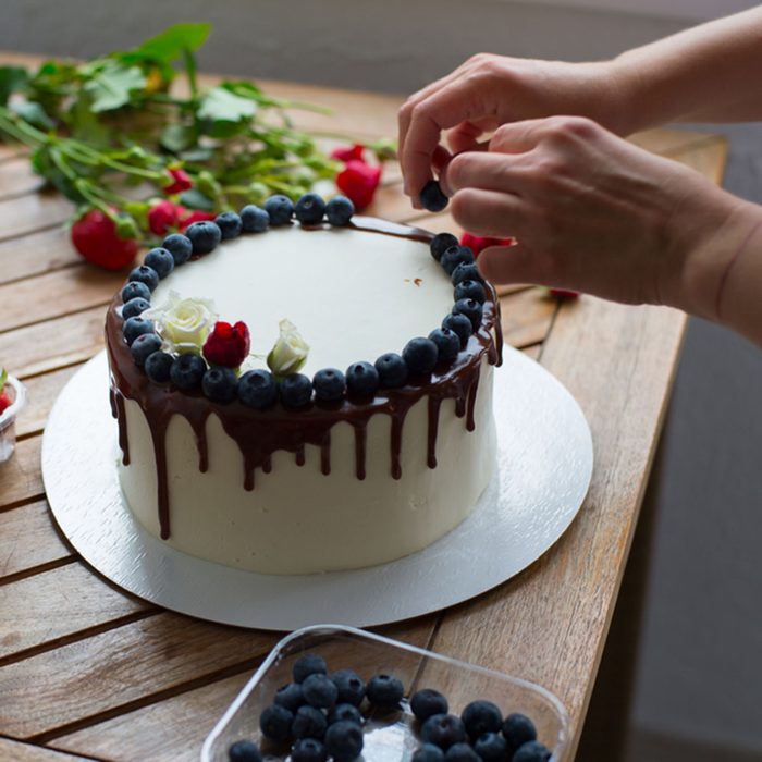 Baker adding blueberries to a cake; Shutterstock ID 645905908; Job (TFH, TOH, RD, BNB, CWM, CM): Taste of Home