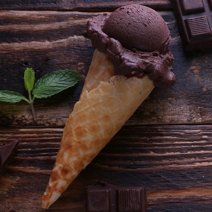 Chocolate Ice cream cone and chocolate bar on wooden table.; Shutterstock ID 660218128; Job (TFH, TOH, RD, BNB, CWM, CM): Taste of Home