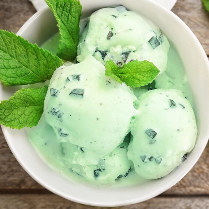 Bowl with mint chocolate chip ice cream on wooden table; Shutterstock ID 703635190; Job (TFH, TOH, RD, BNB, CWM, CM): Taste of Home