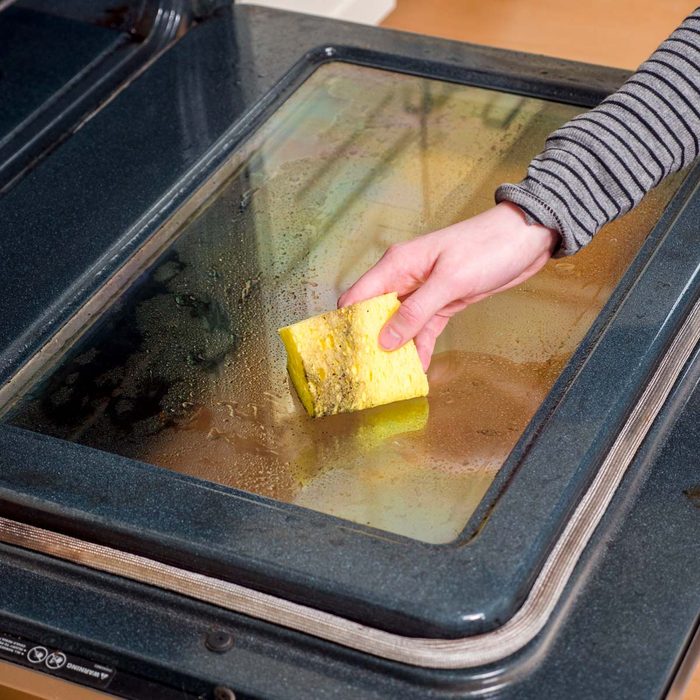 Using a sponge-cleaning an oven window