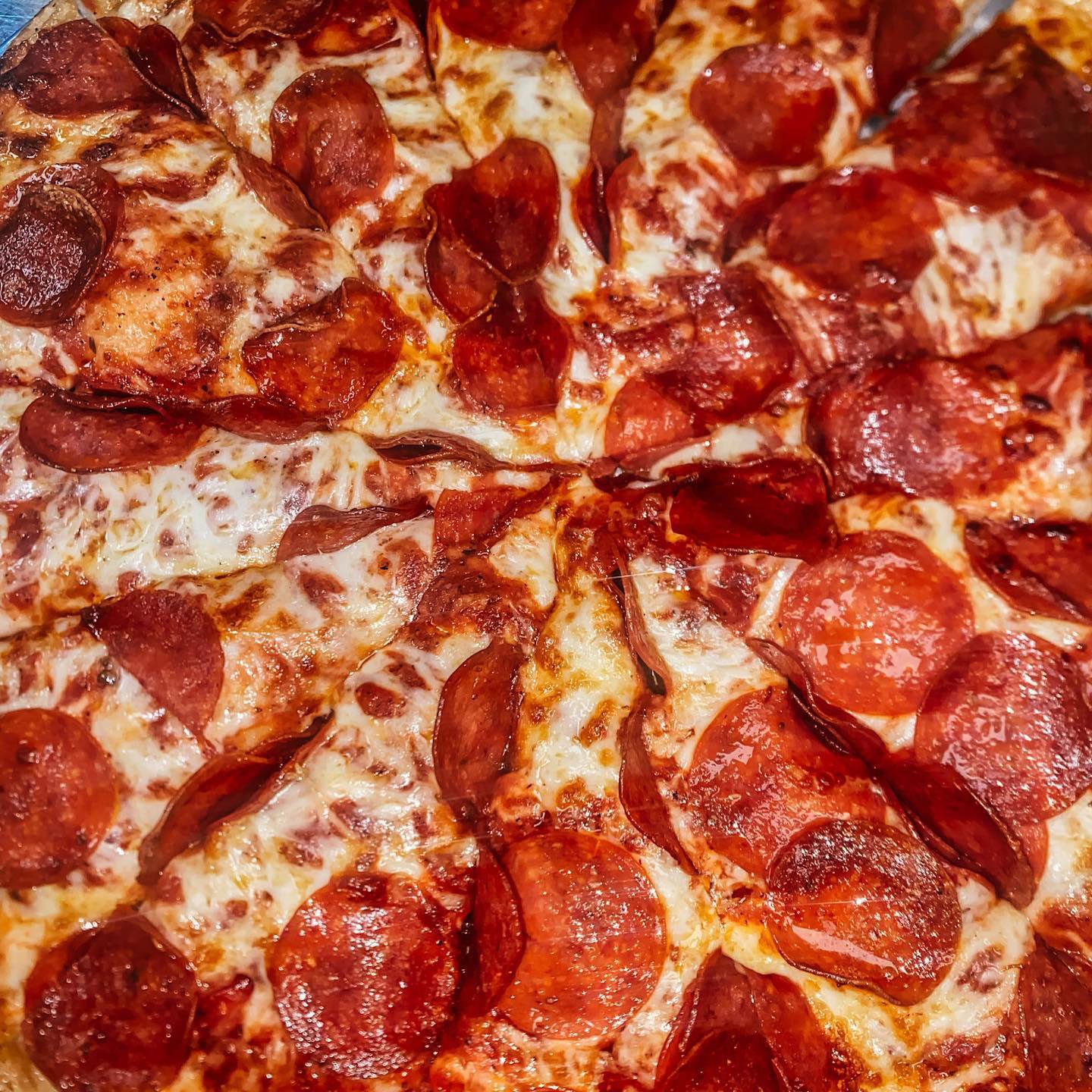 close up of a cheese and pepperoni pizza from Angelos Lakewood