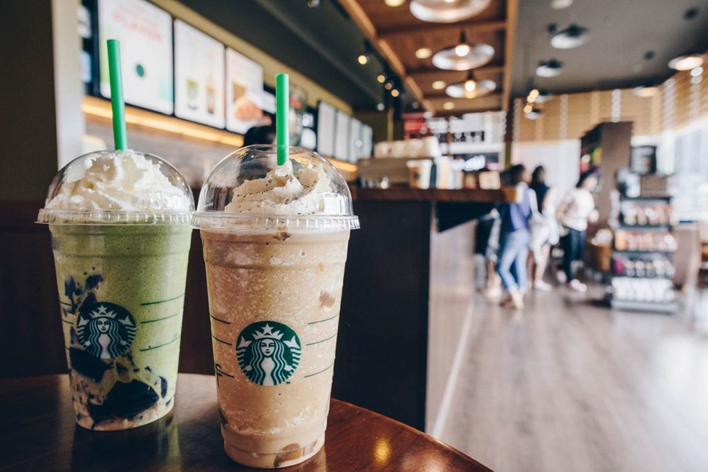 Two Starbucks blended drinks on a table
