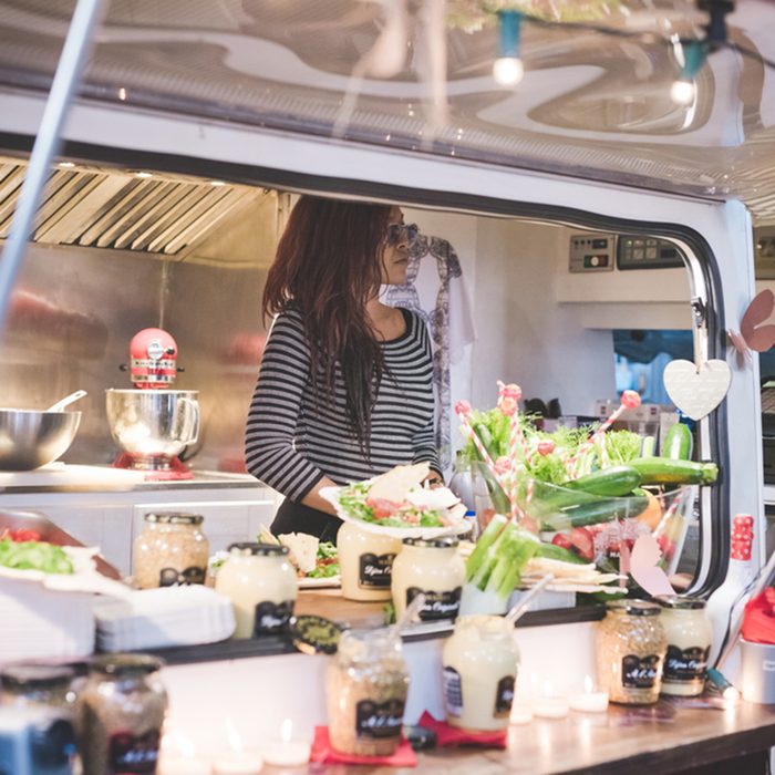 Woman inside her food truck waiting for customer