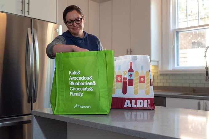 Woman unpacking Instacart groceries