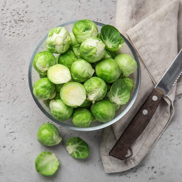 fresh raw brussel sprouts in glass bowl.