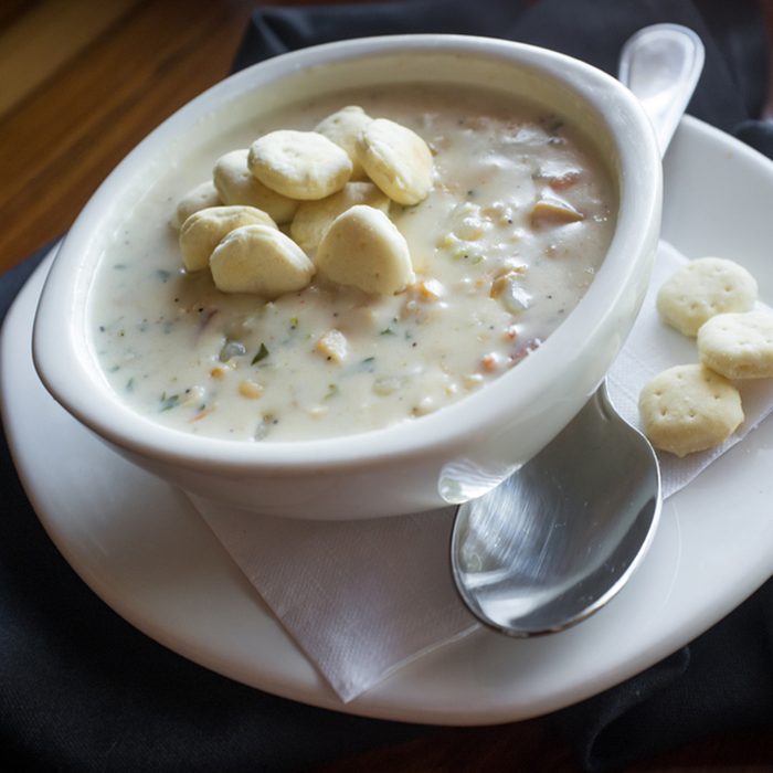 Creamy New England Clam Chowder garnished with oyster crackers