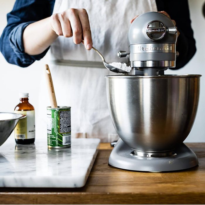 blue KitchenAid mixer with flour