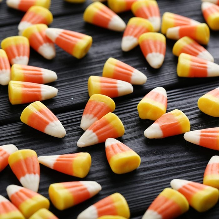 Halloween candy corns on black wooden background