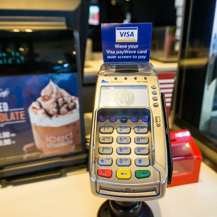 Credit and debit card reader at the cash register at McDonald McCafe restaurant.
