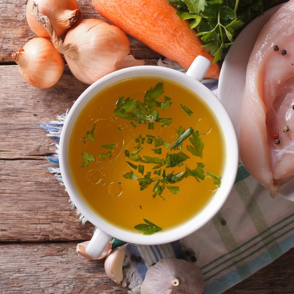 Country style: the chicken broth and the ingredients on the table.