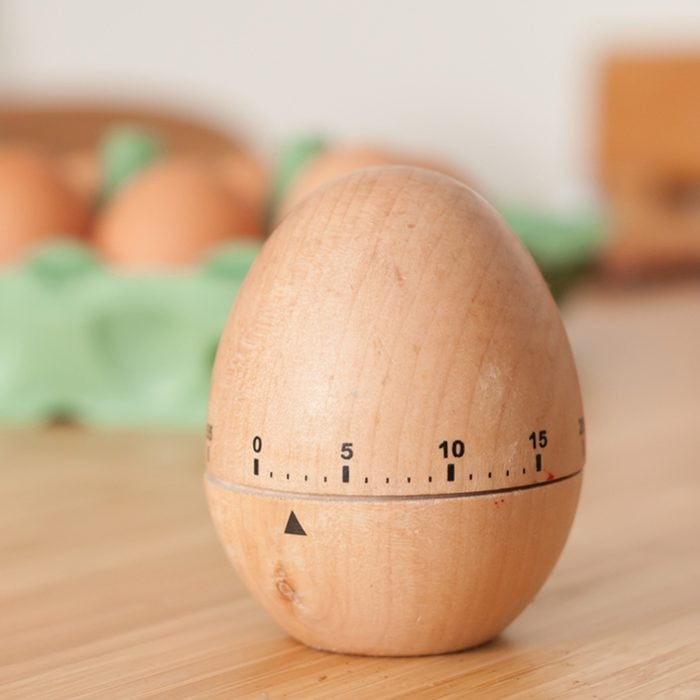 Egg timer with open carton of eggs