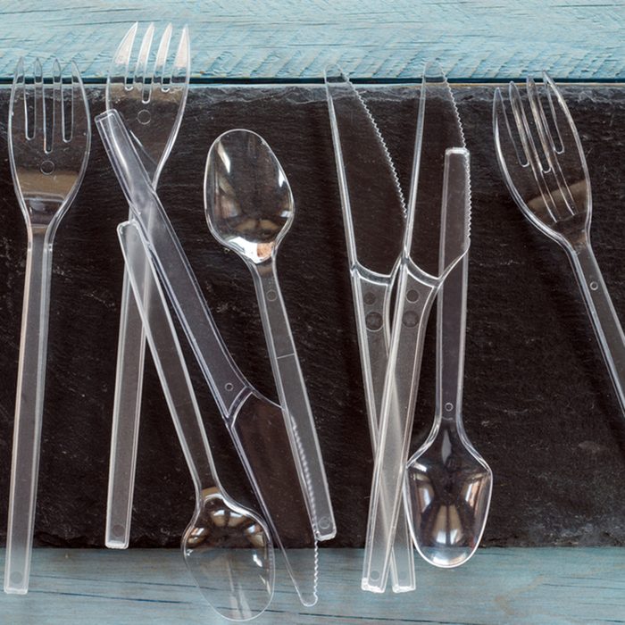 transparent plastic cutlery on black background