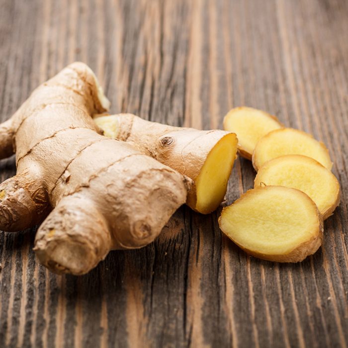 Ginger root sliced on wooden table