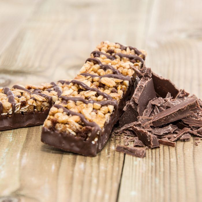 Two Granola Bars with Chocolate on wooden background