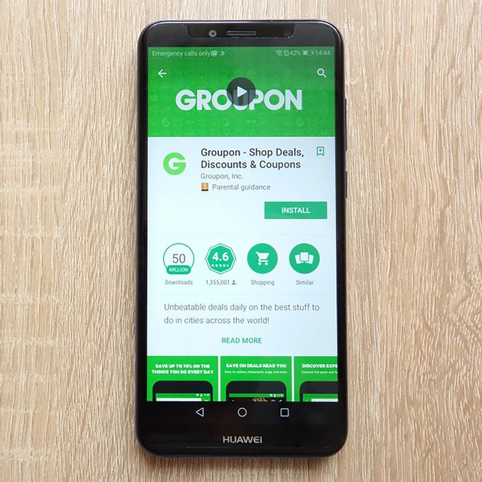Groupon - Shop Deals, Discounts and Coupons app on Google Play Store website displayed on Huawei Y6 2018 smartphone