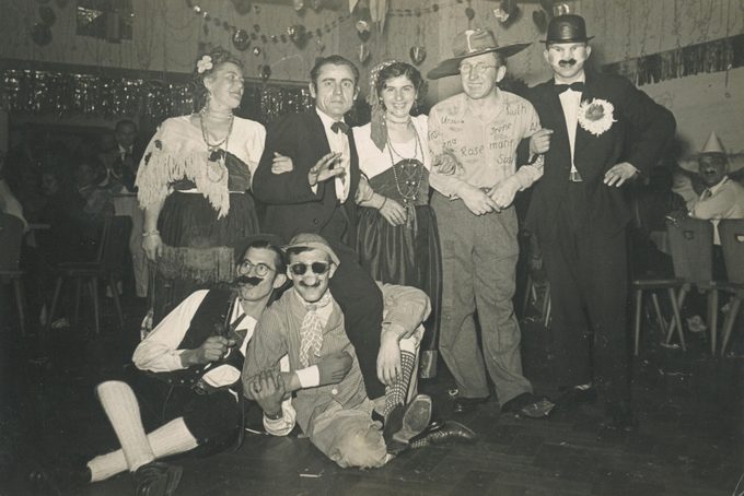 Portrait of a group of friends in fancy dress on a night out, circa 1950s