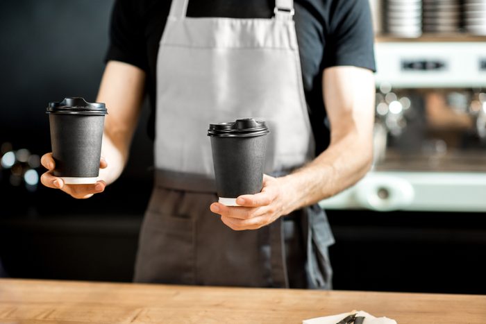 Barista holding paper cups to take away with coffee on the counter of the coffee shop; Shutterstock ID 1087957532; Job (TFH, TOH, RD, BNB, CWM, CM): TOH National Free Coffee Day