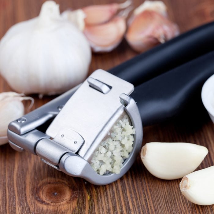 Garlic press and garlic; Shutterstock ID 154261304; Job (TFH, TOH, RD, BNB, CWM, CM): Taste of Home