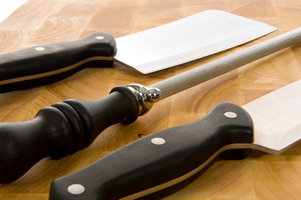 Kitchen knives including chef's knife, cleaver and sharpening steel on wooden cutting board; Shutterstock ID 2740749; Job (TFH, TOH, RD, BNB, CWM, CM): Taste of Home