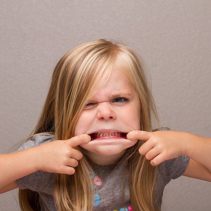 Young girl making funny faces showing her teeth; Shutterstock ID 343761566; Job (TFH, TOH, RD, BNB, CWM, CM): -