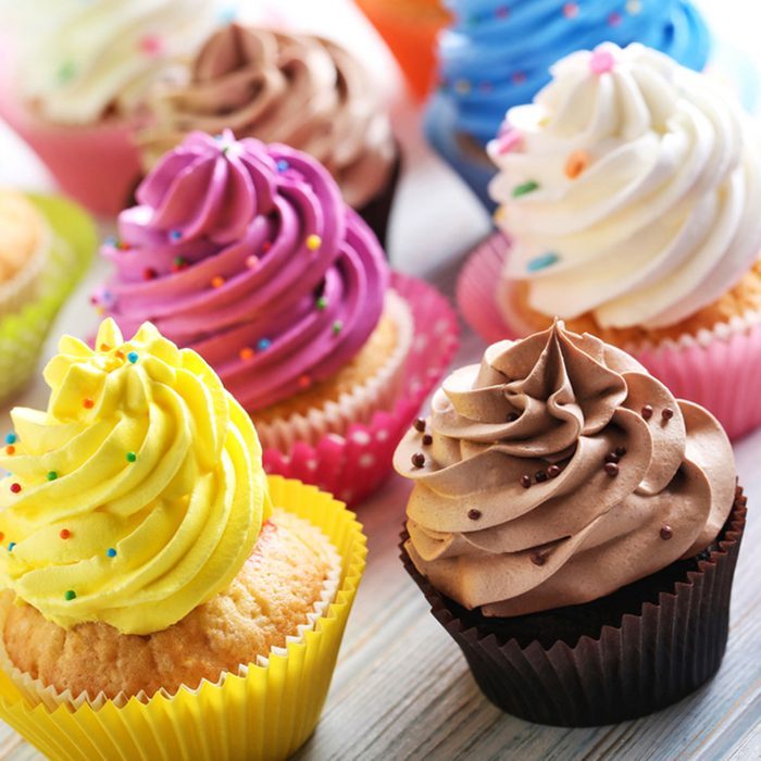 Tasty cupcakes on a white wooden table; Shutterstock ID 556435444; Job (TFH, TOH, RD, BNB, CWM, CM): Taste of Home