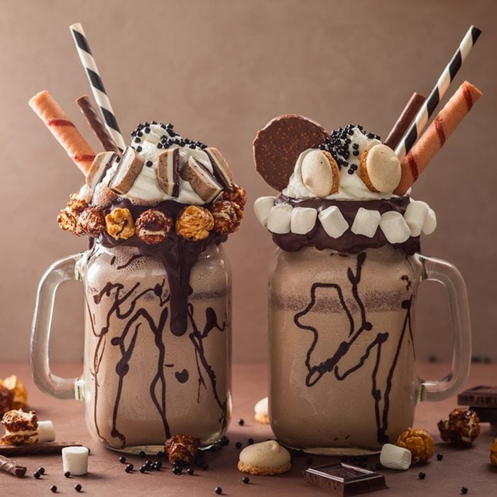 Chocolate milkshake with ice cream and with whipped cream, marshmallow, sweet popcorn, cookies, waffles, served in glass mason jar. "Freak or crazy" sweet shake.; Shutterstock ID 667618195; Job (TFH, TOH, RD, BNB, CWM, CM): Taste of Home
