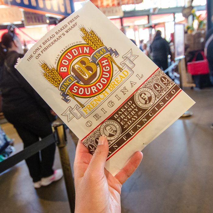 A hand holds up a Boudin Bakery cookie package from the famous sourdough bread restaurant and store.
