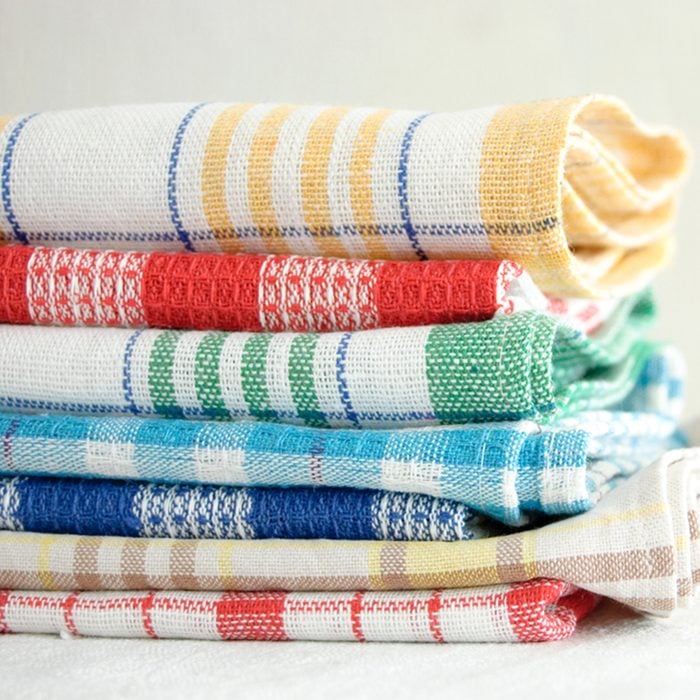 Pile of linen kitchen towels on a white background