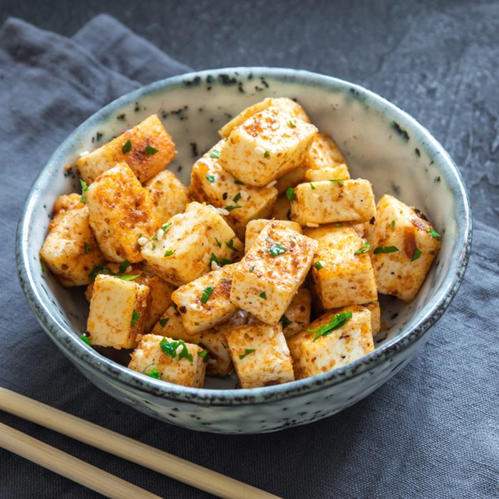 Stir Fried Tofu in a bowl with sesame and greens.