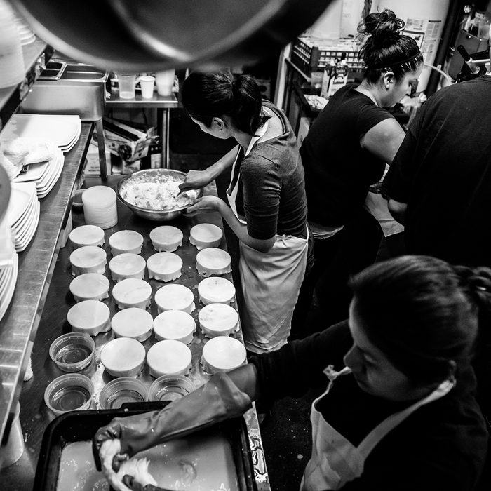 Black and white photograph of working in a restaurant kitchen