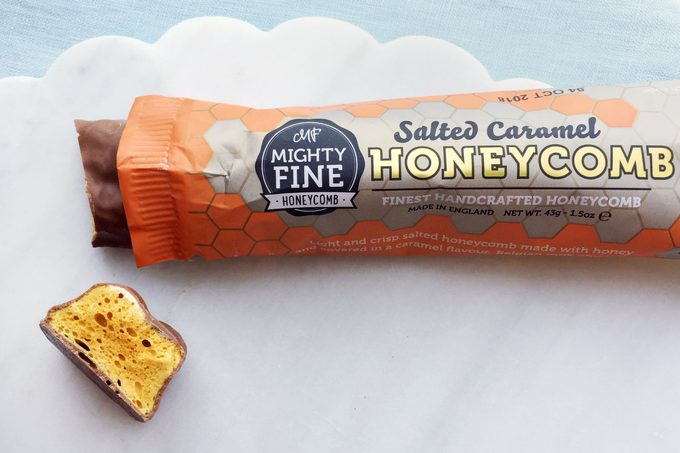 Mighty Fine Honeycomb Bar Chocolate bar on a marble surface with a blue tablecloth
