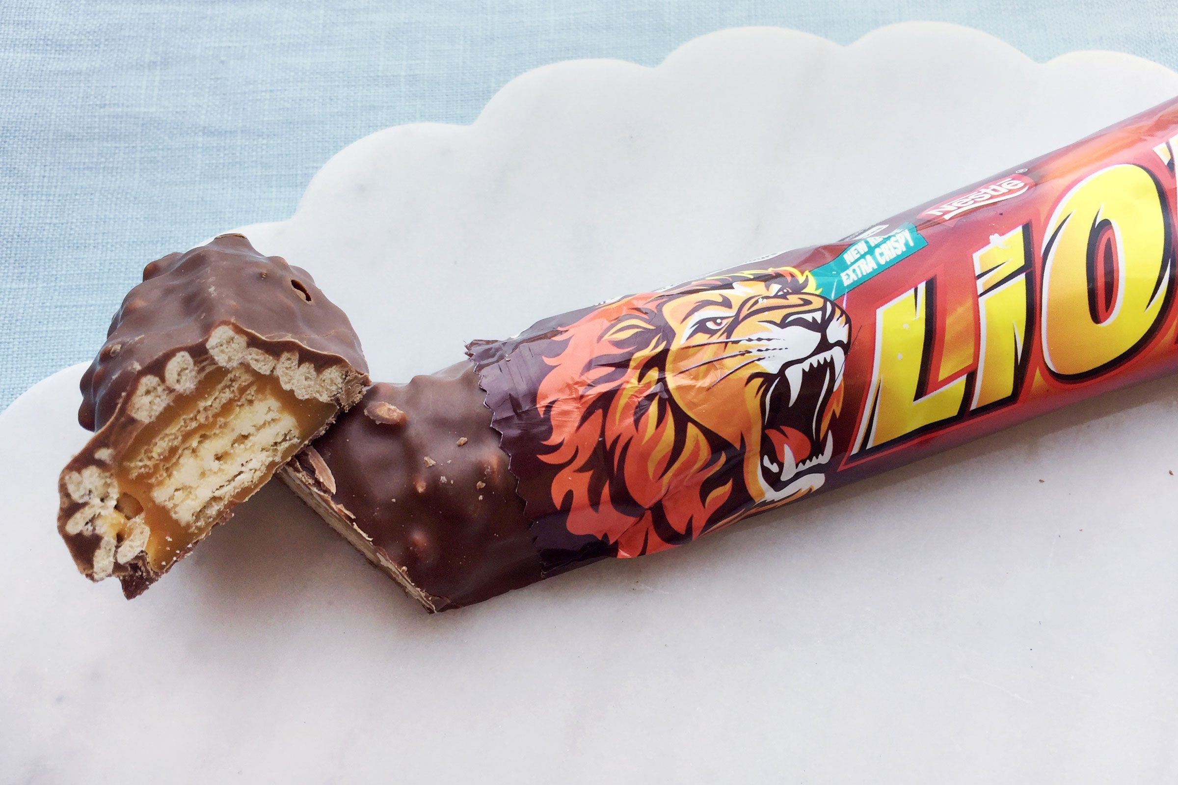 Lion chocolate Bar on a marble surface with a blue table cloth