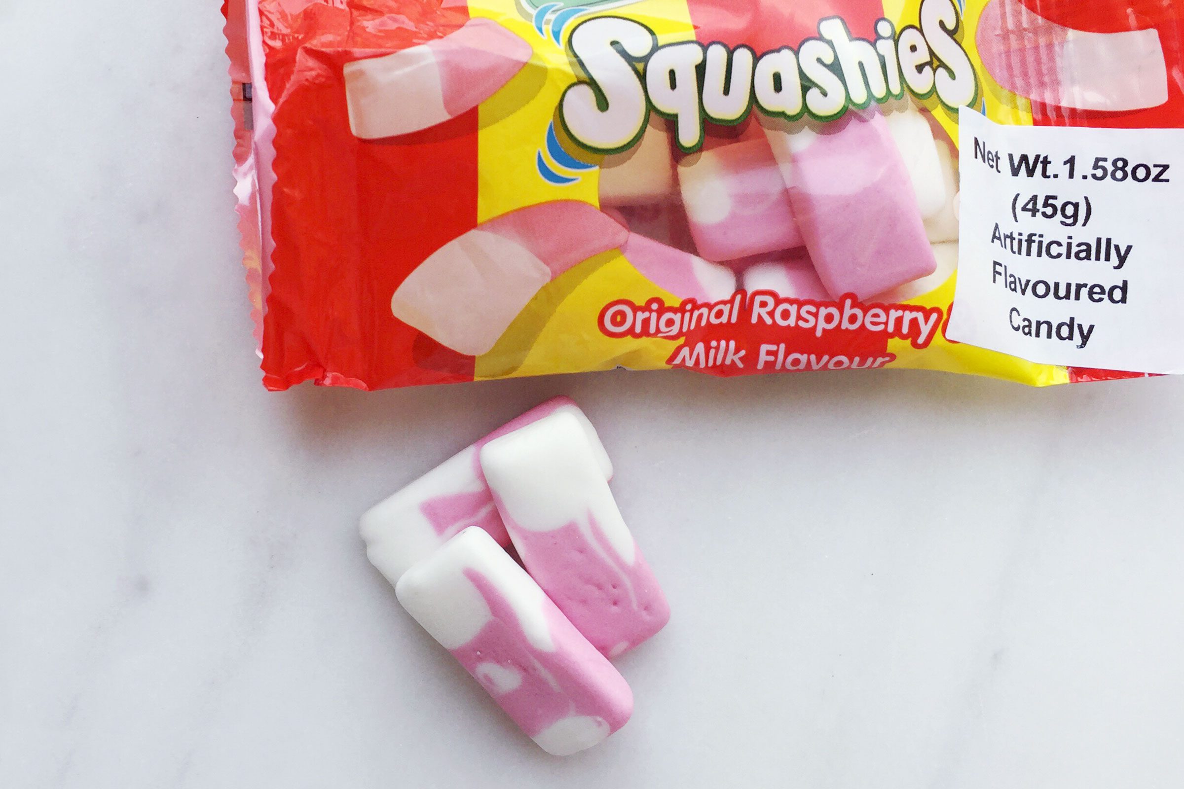 Drumstick Squashies British candy on a marble surface