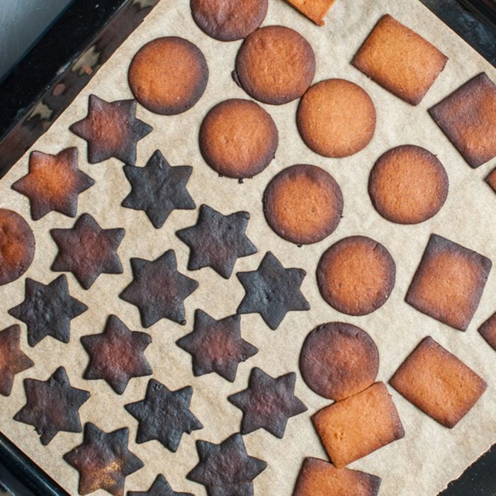 Baking tray with burnt gingerbread cookies