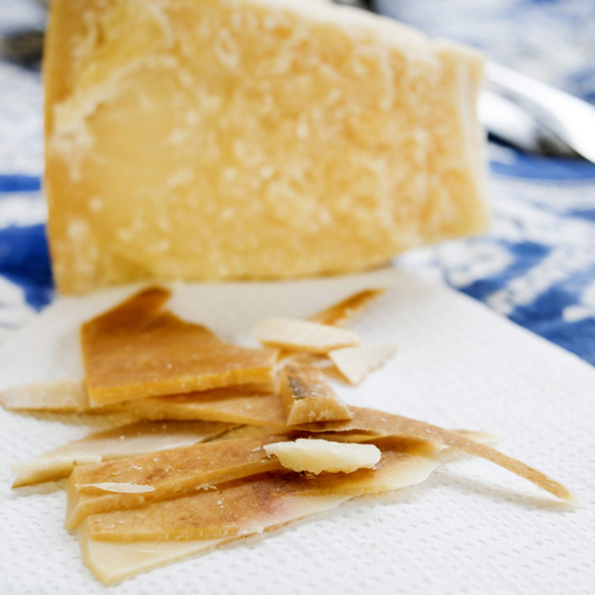 chunks and rind of parmigiano cheese with near a big piece of heart